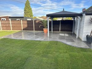 New fence, freshly laid lawn, patio, and wooden gazebo by GND Landscaping & Building in Harwich, UK, showcasing comprehensive garden design and construction services.