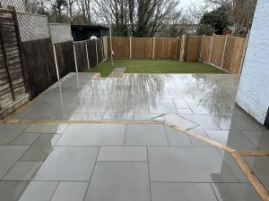 Freshly laid lawn, newly installed patio, and newly erected fence by GND Landscaping & Building in Harwich, UK, highlighting professional garden landscaping and fencing services.