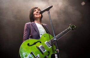 Texas band performing live on stage with lead singer Sharleen Spiteri holding a microphone, set against the backdrop of an enthusiastic crowd. Colchester Castle Summer Series